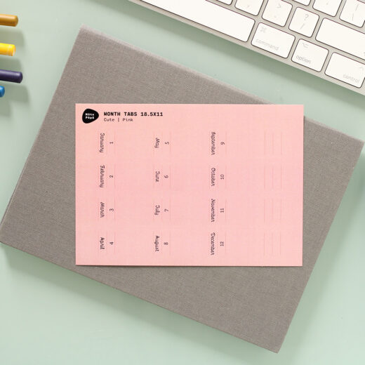 Noto Pepa Peachy Pink Month Tabs Stickersheet for a year on notebook at a work desk with keyboard and pencils